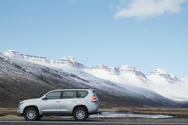 Gray SUV car near snow covered mountain